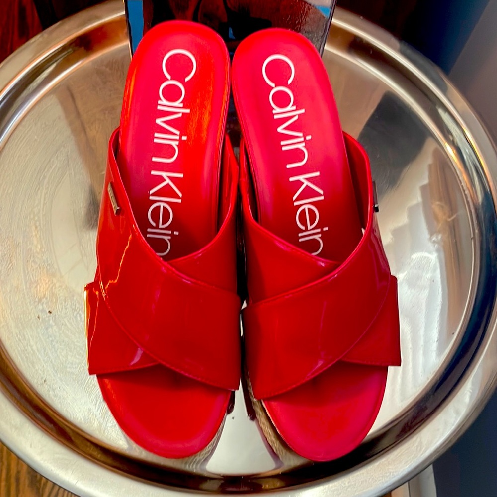 Red Calvin Klein Wedge Sandals, never worn outside.  Adds a great pop of color!